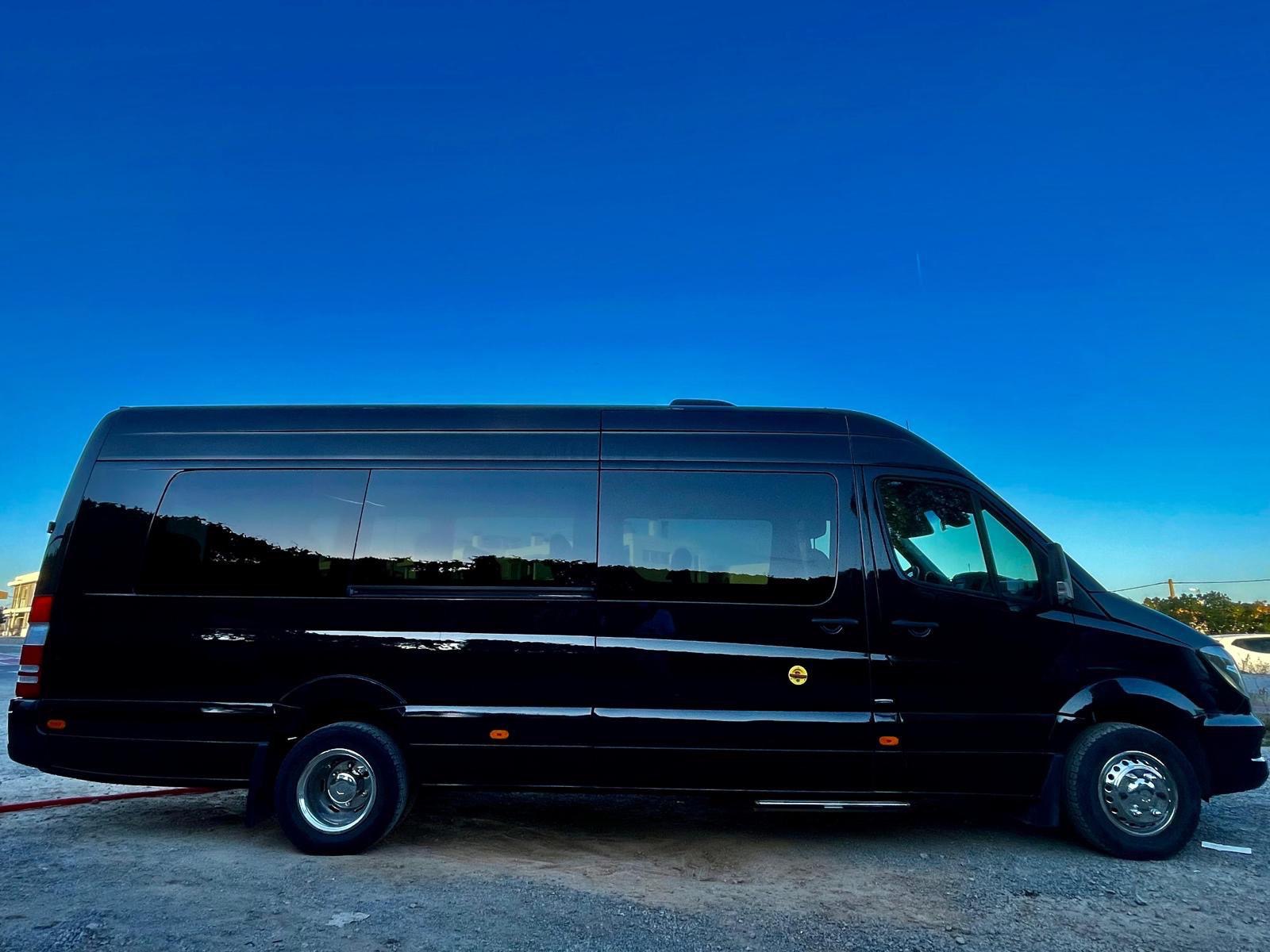 Side view of the blacked out party bus at dusk
