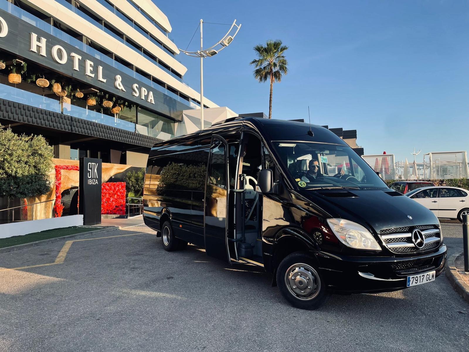 Black Mercedes Sprinter party bus outside a hotel in Ibiza